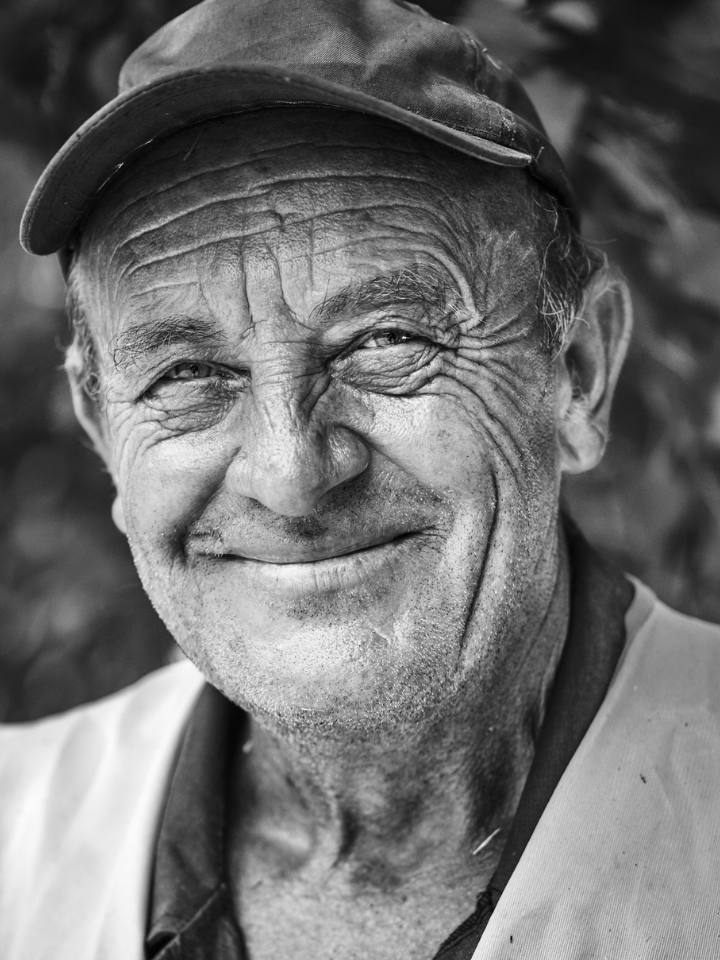 black and white portrait of an elderly man smiling