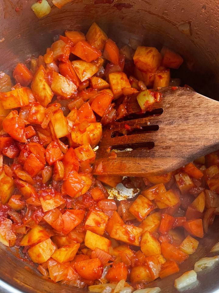 next step in the recipe of Tomato paste added to the vegetables in the pot